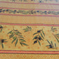 Toile cirée au mètre jaune et trait rouge motifs branche olive