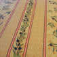 Toile cirée au mètre jaune et trait rouge motifs branche olive